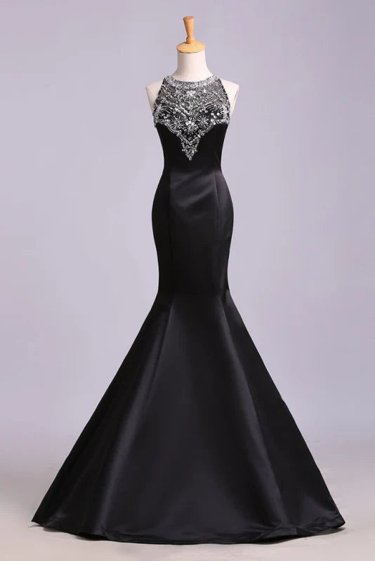 Elegant mermaid prom dress in satin with beaded bodice and sweetheart neckline.
