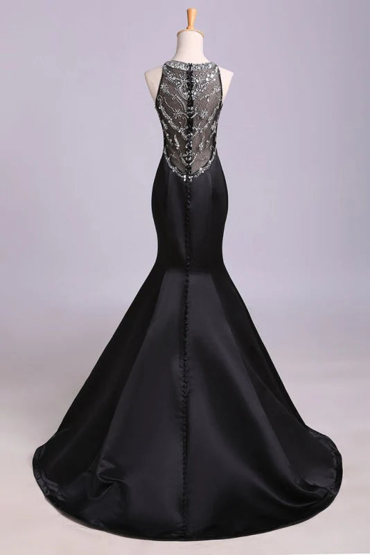 Close-up of the intricate beading on the bodice of the satin mermaid prom dress.