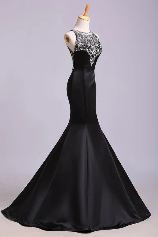 Back view of the long satin mermaid prom dress, highlighting the flowing skirt.