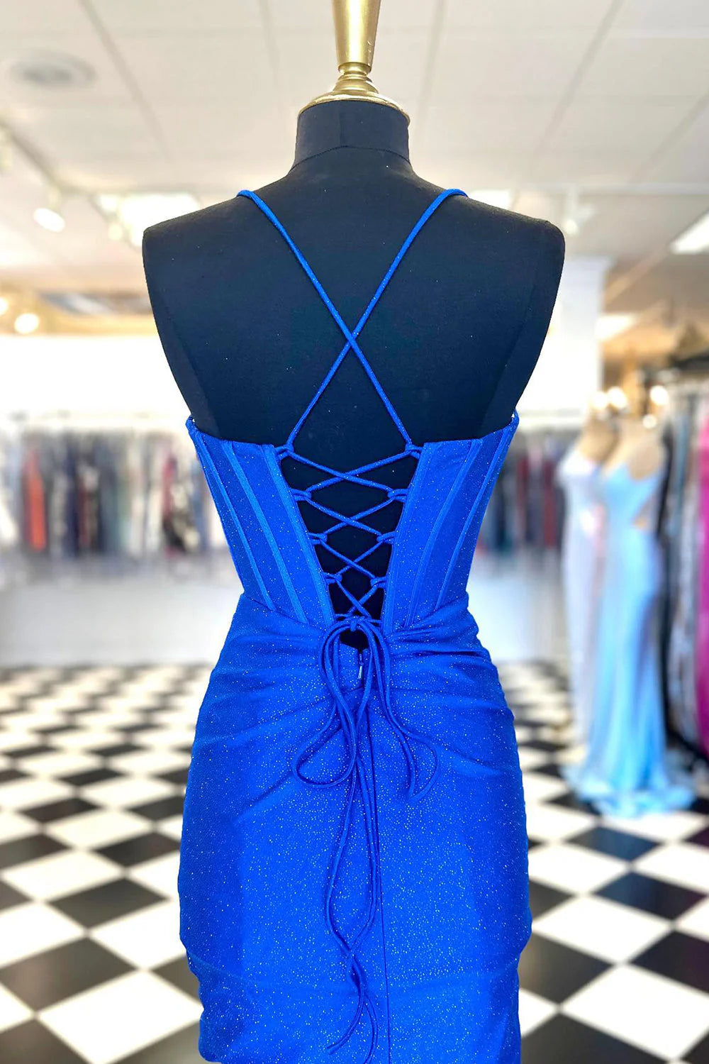 Close-up of the intricate beaded detailing on a short sheath homecoming dress.