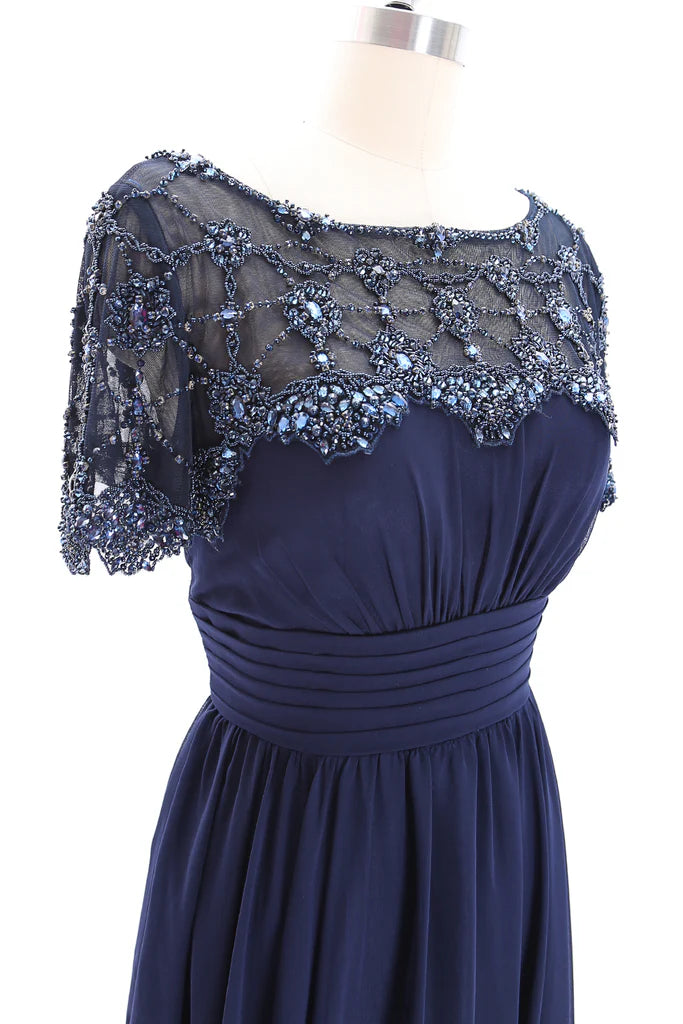 Close-up of beading detail on a formal gown sleeve.