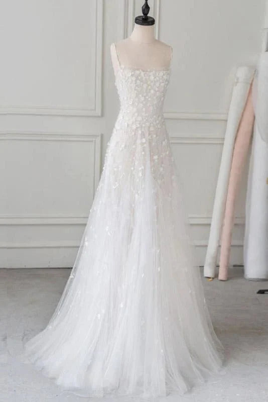 Elegant beaded prom dress with spaghetti straps and lace details.