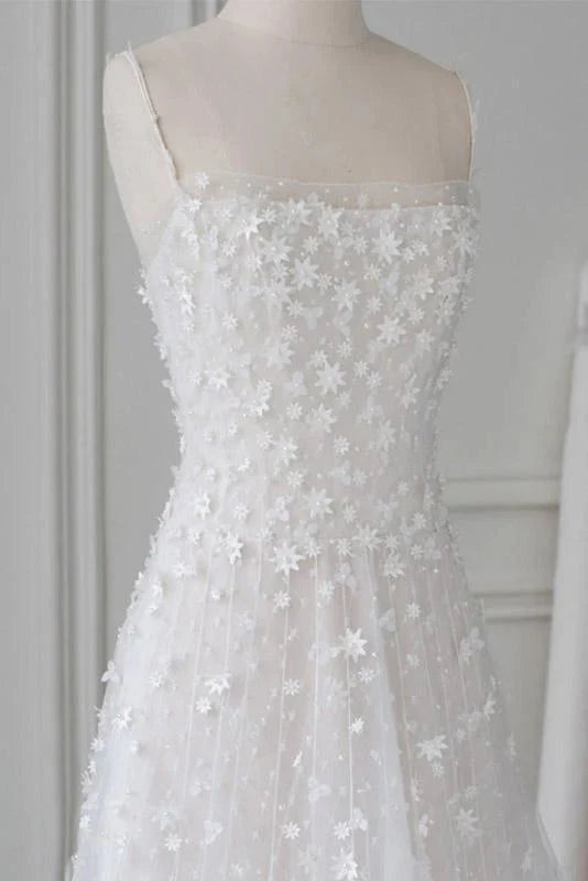 Close-up of the lace and bead embellishments on a sweetheart prom dress.