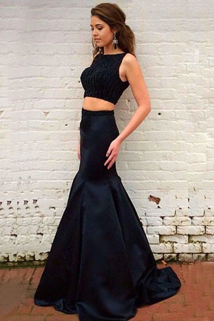 Elegant black two-piece mermaid formal dress with intricate beading and a sweep train.