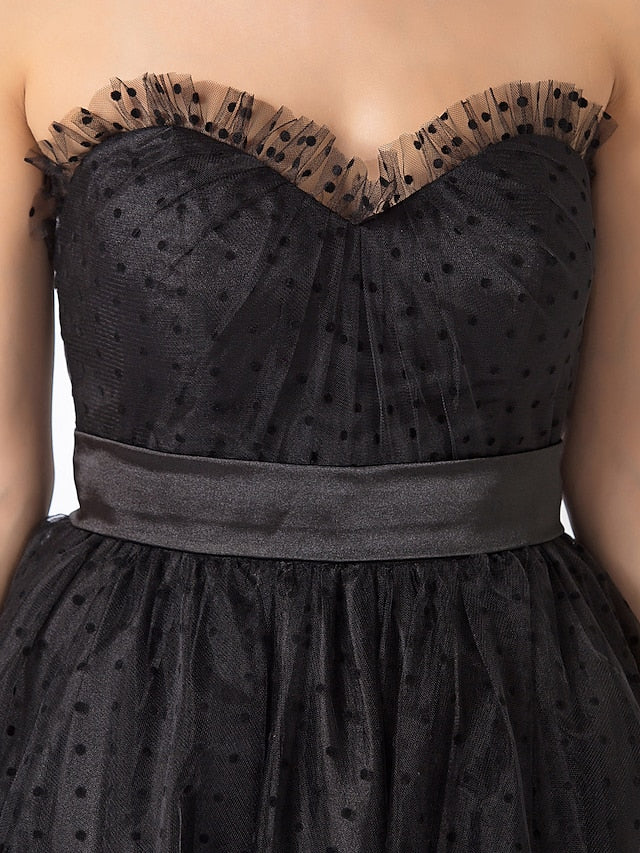 Close-up of the sweetheart neckline and bodice of the black tulle dress.
