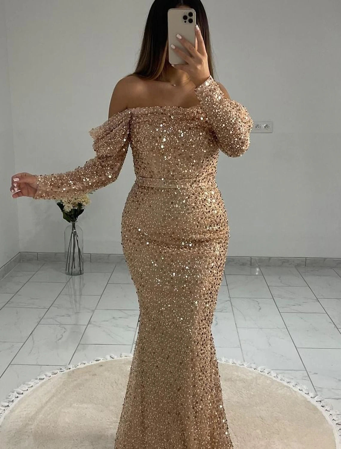 Back view of a woman wearing the black sequined mermaid formal dress with floor-length silhouette.