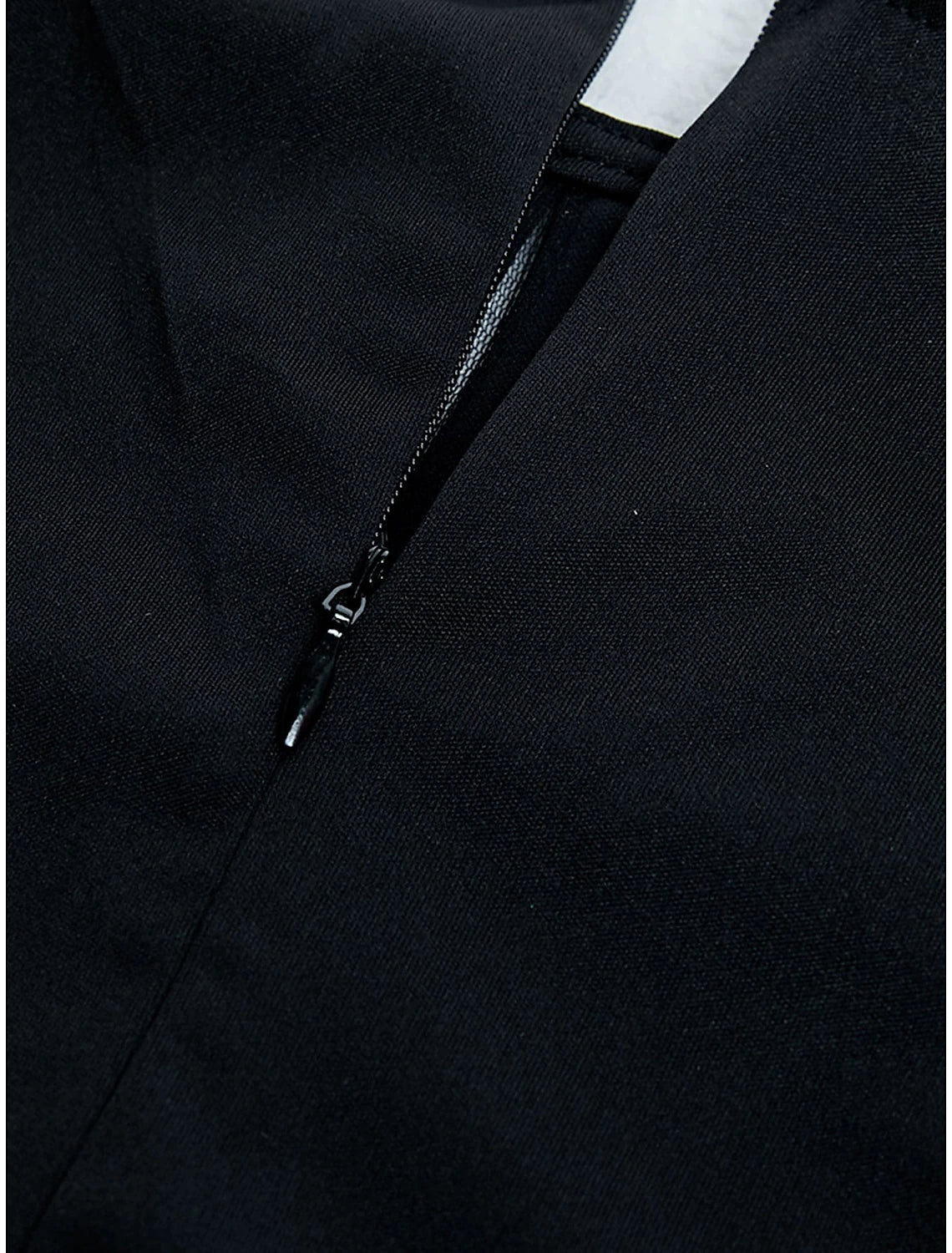 Side view of a black mermaid evening gown with pleats.