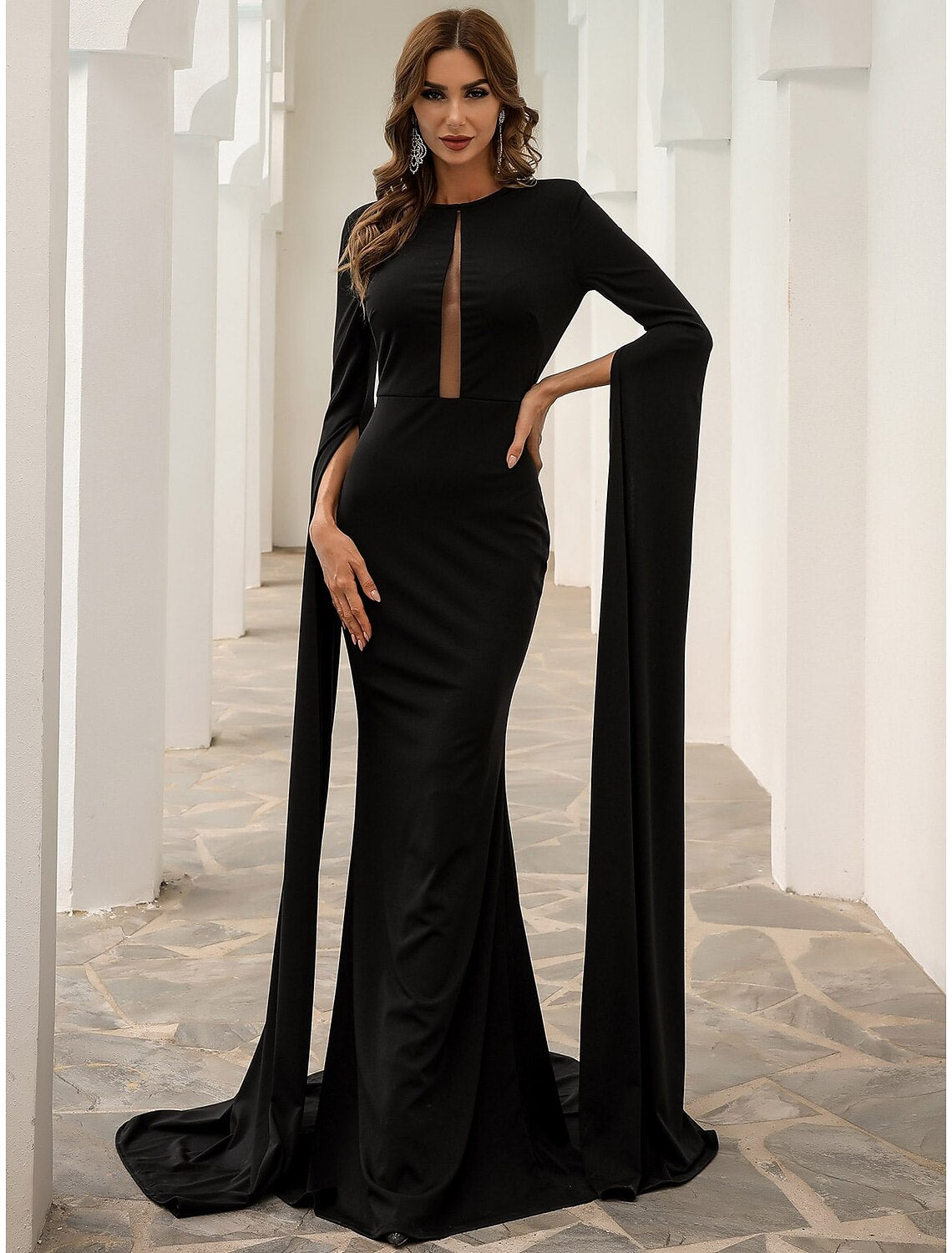 Close-up of the jewel neck and long sleeve detail on a black gown.