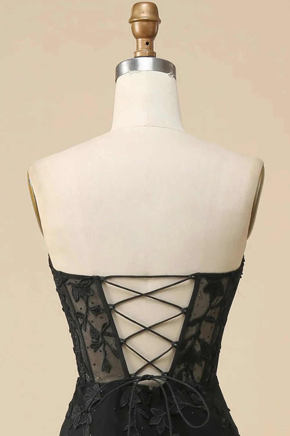 Side view of the black mermaid prom dress, highlighting the slit and silhouette.