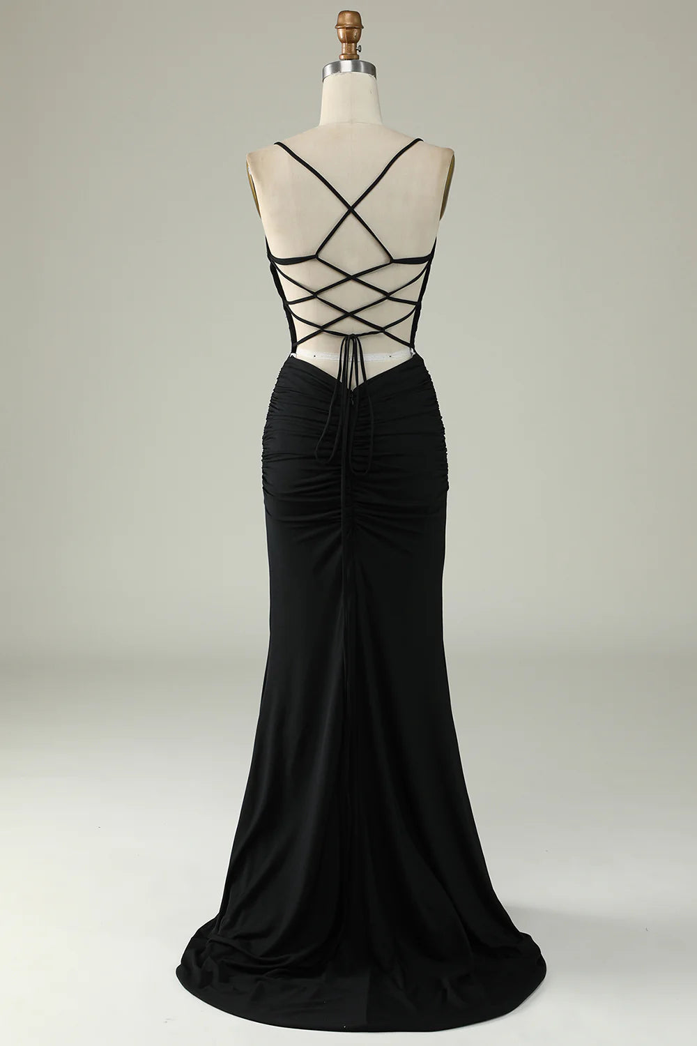 Model wearing a black mermaid formal dress, side view.