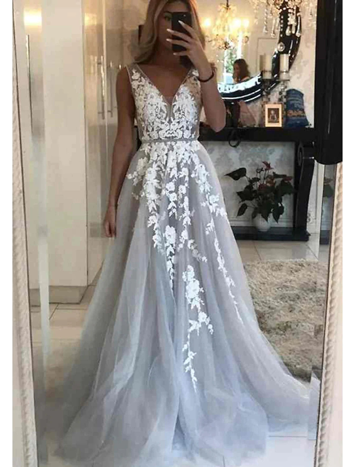 Elegant black off-shoulder ball gown with floral appliques and court train.