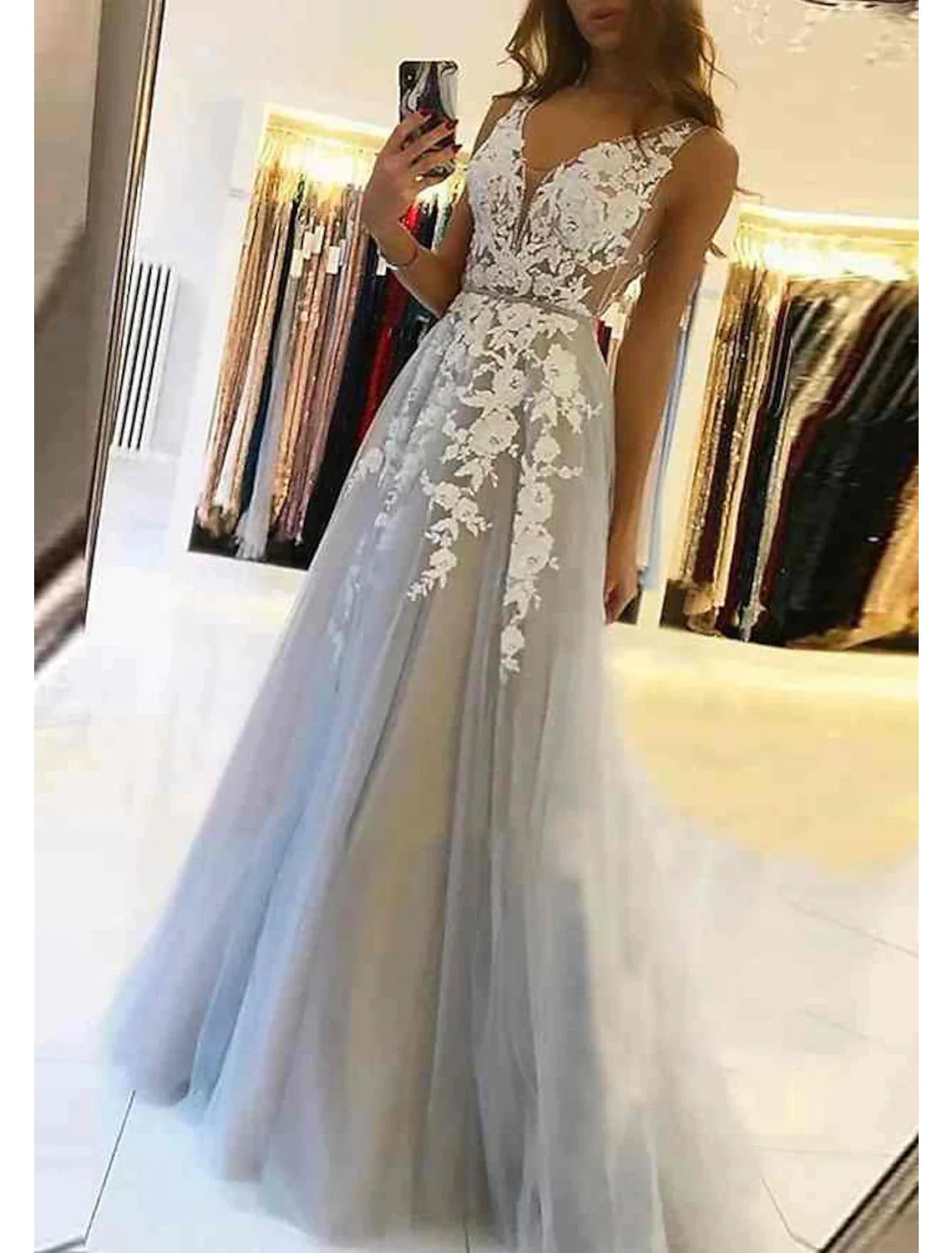 Close-up of floral appliques and intricate beading on black ball gown.