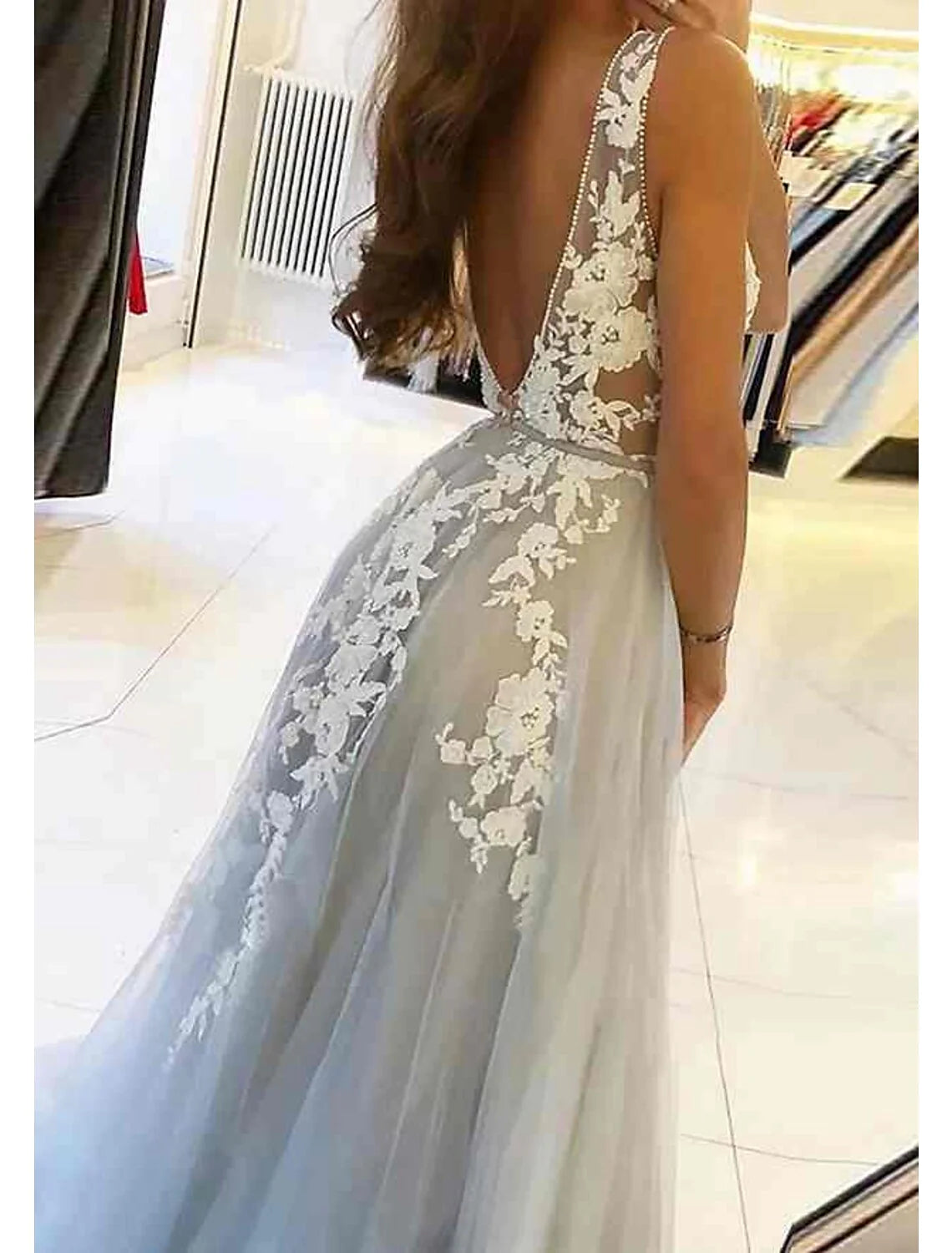 Full length view of black off-shoulder ball gown, highlighting silhouette and train.