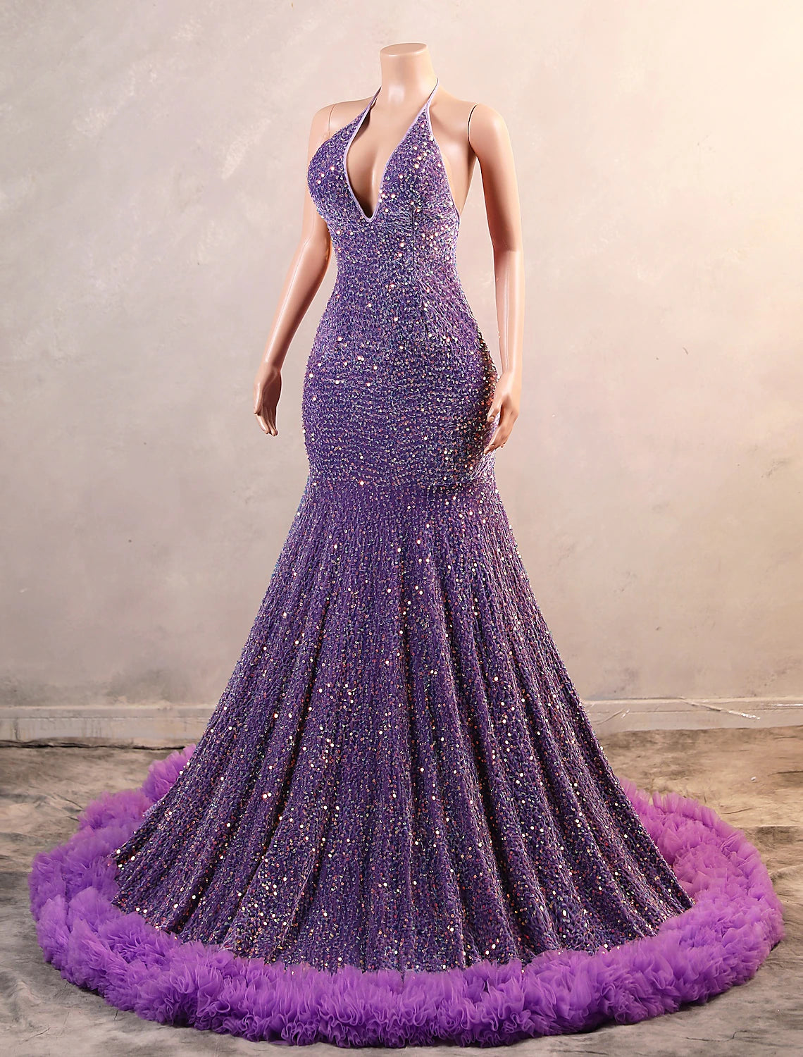 Woman posing in the black sequined mermaid gown, showcasing the floor-length design.
