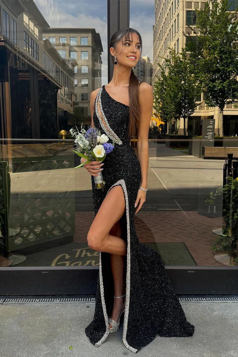 Elegant black sequined mermaid one-shoulder long prom gown with intricate beading.