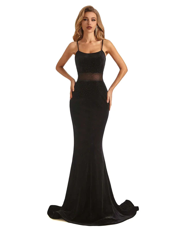 Black velvet mermaid prom dress with spaghetti straps and intricate beading.