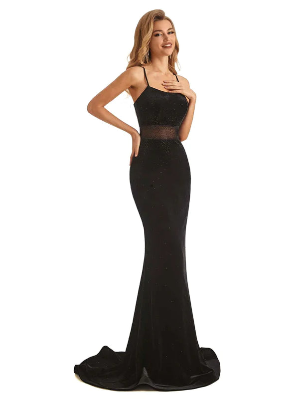 Side view of a black velvet floor-length mermaid gown.