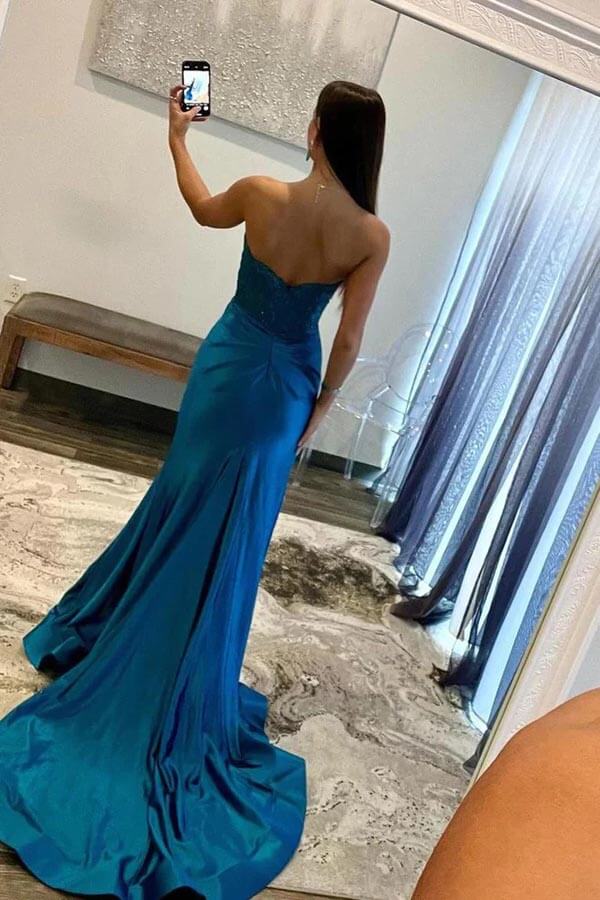 Back view of blue mermaid strapless satin prom dress.