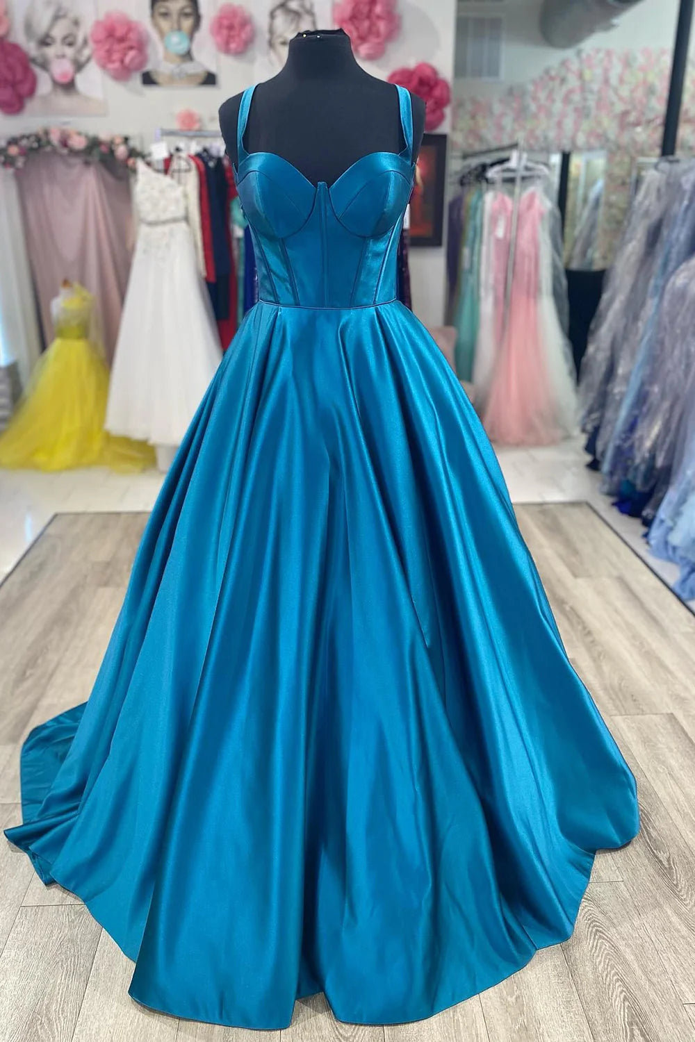 Woman wearing an elegant blue satin corset prom dress.