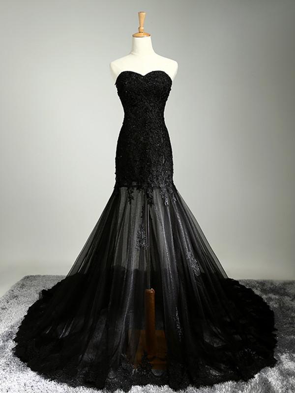Woman wearing a blush mermaid prom dress with sweetheart neckline, lace details, and a sweep train.