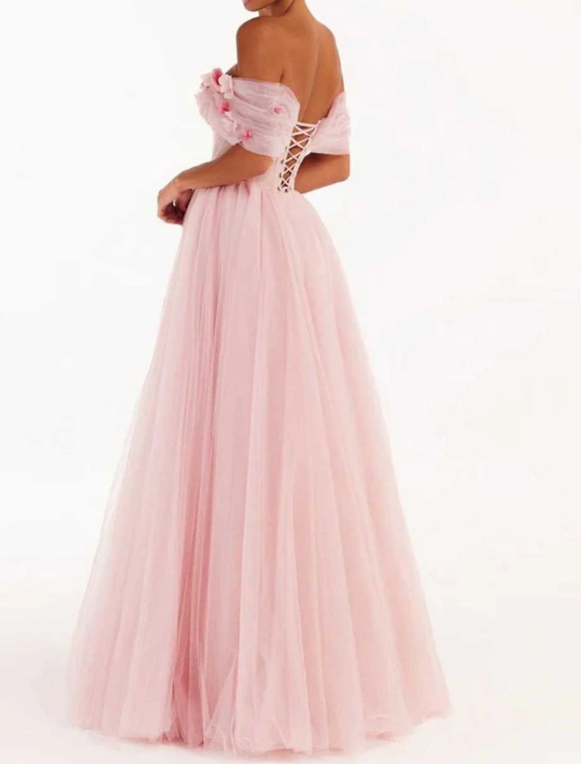 Close-up of floral appliques on blush off-shoulder dress bodice.