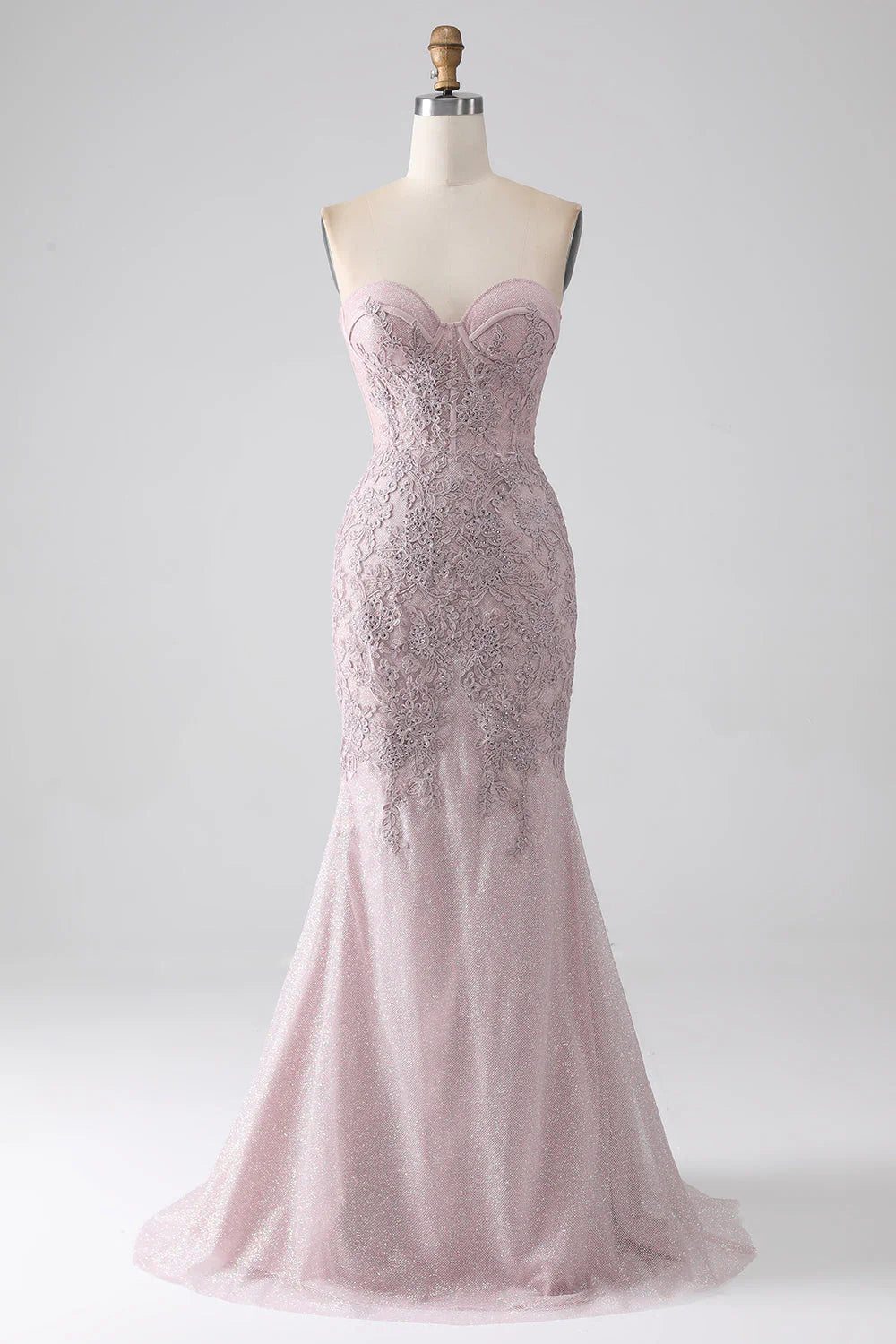 Blush mermaid prom dress with sweetheart corset and appliques.