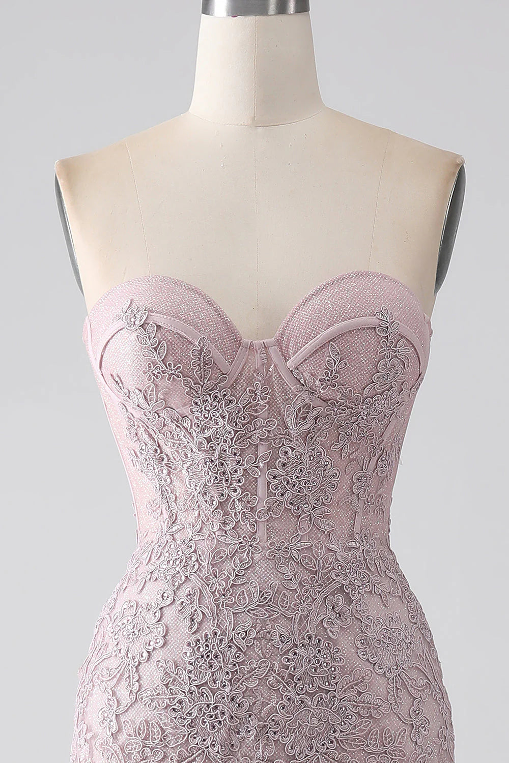 Back view of blush mermaid prom dress with corset lacing.