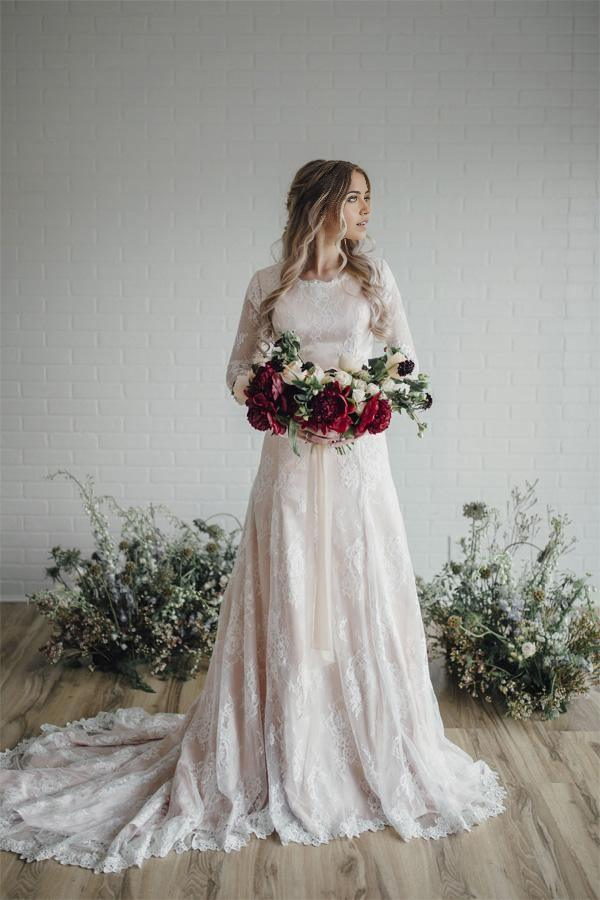 Elegant bodycon long sleeve lace wedding gown with round neck.