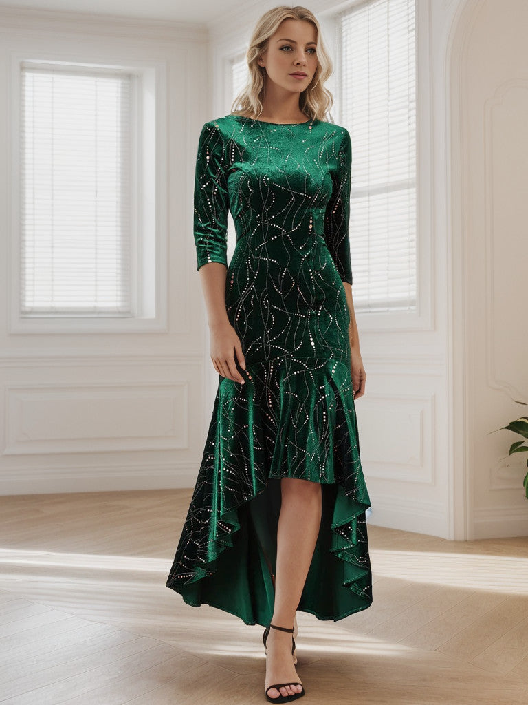 Woman posing in a dark green velvet bodycon high-low dress.