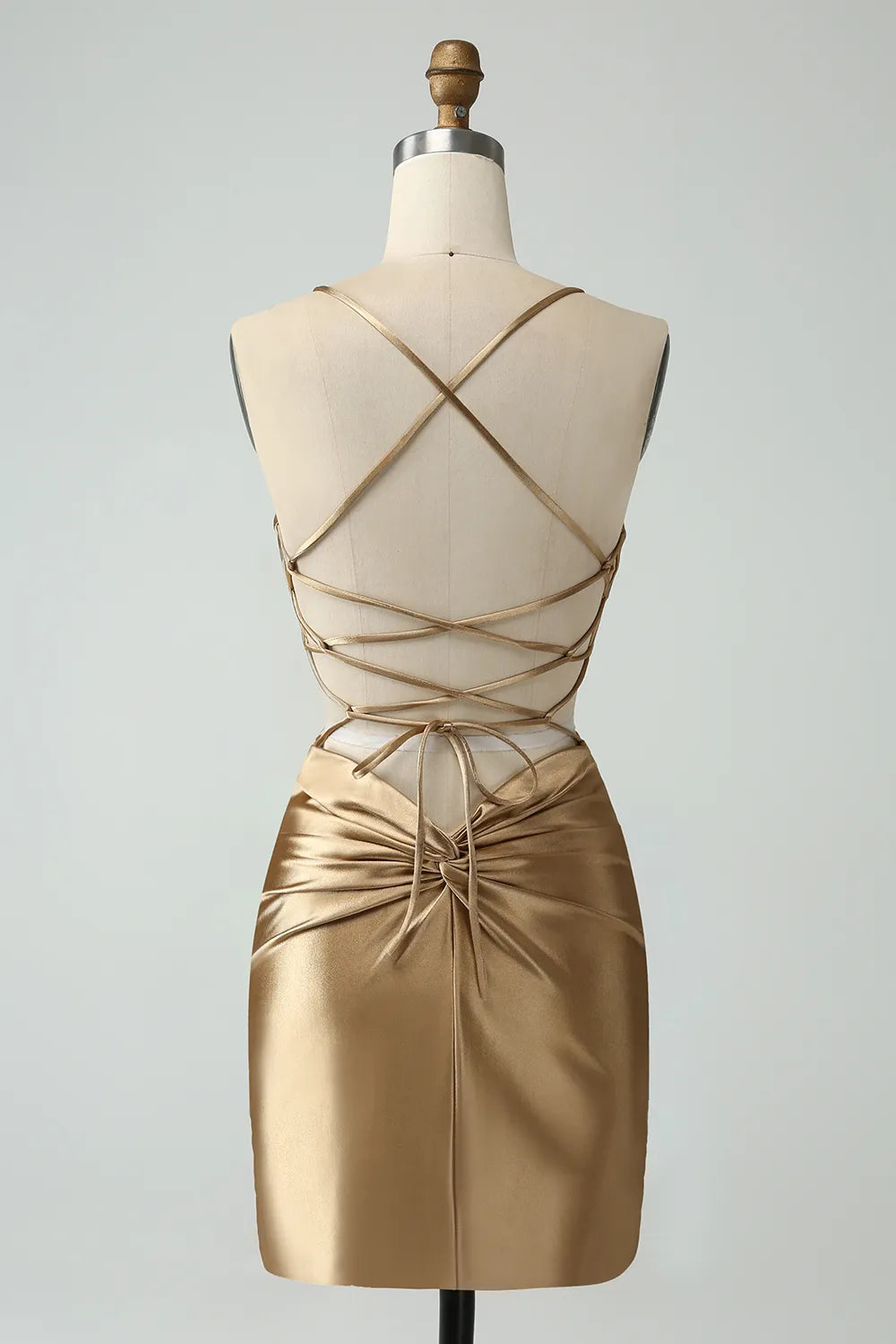 Back view of golden bodycon satin dress with criss-cross straps.