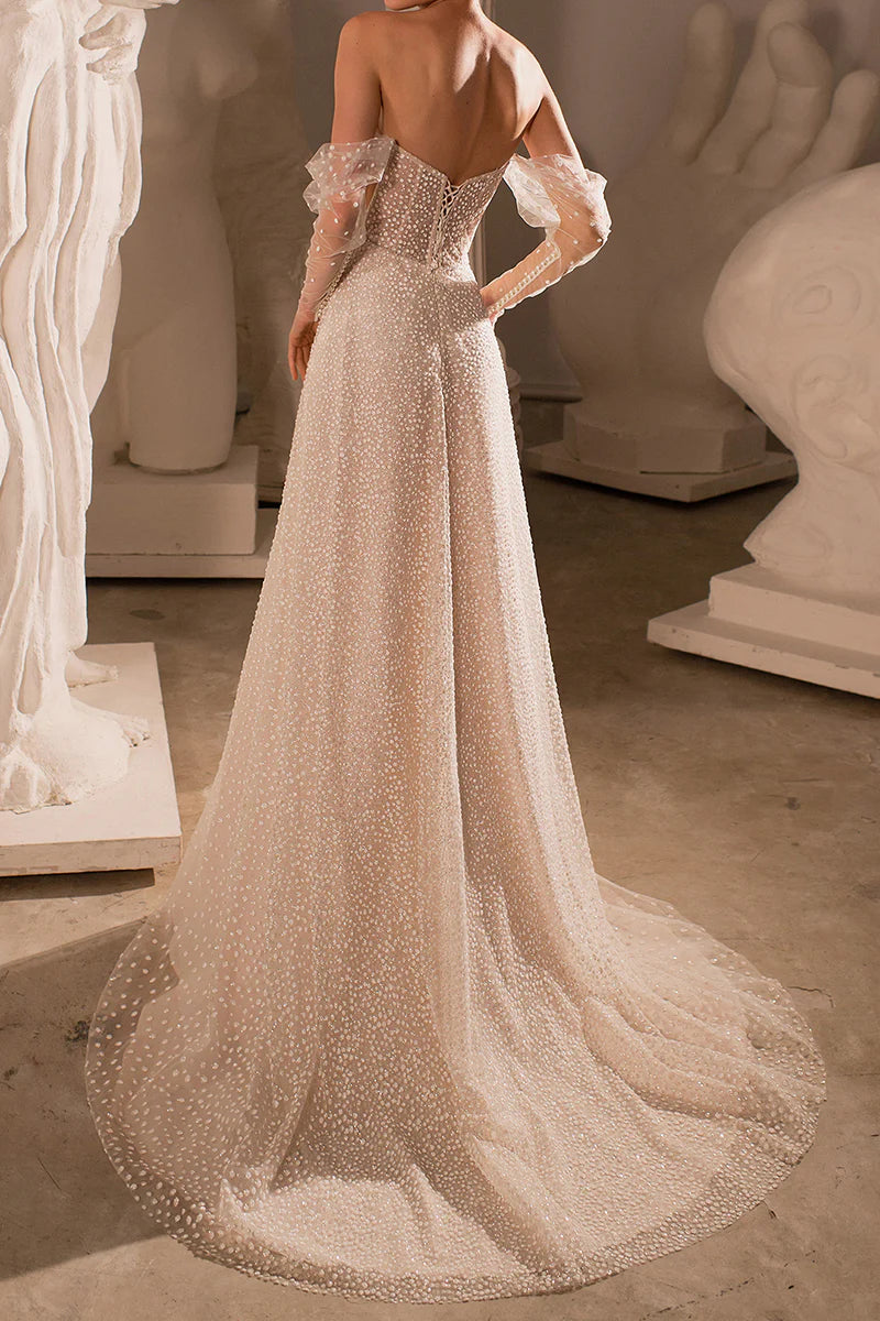 Back view of a flowing A-line beach wedding gown.