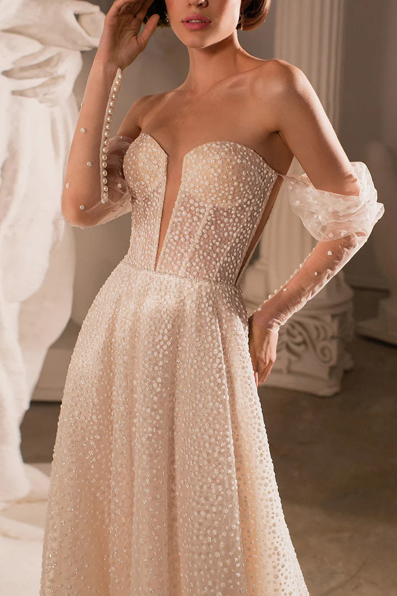 Side profile of a sleeveless deep V-neck bridal dress.