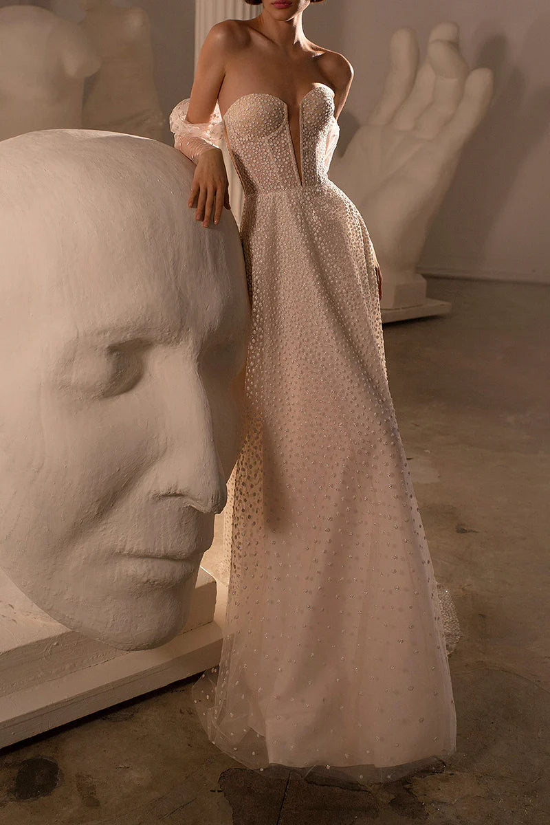 Model posing in an ankle-length Boho wedding gown.