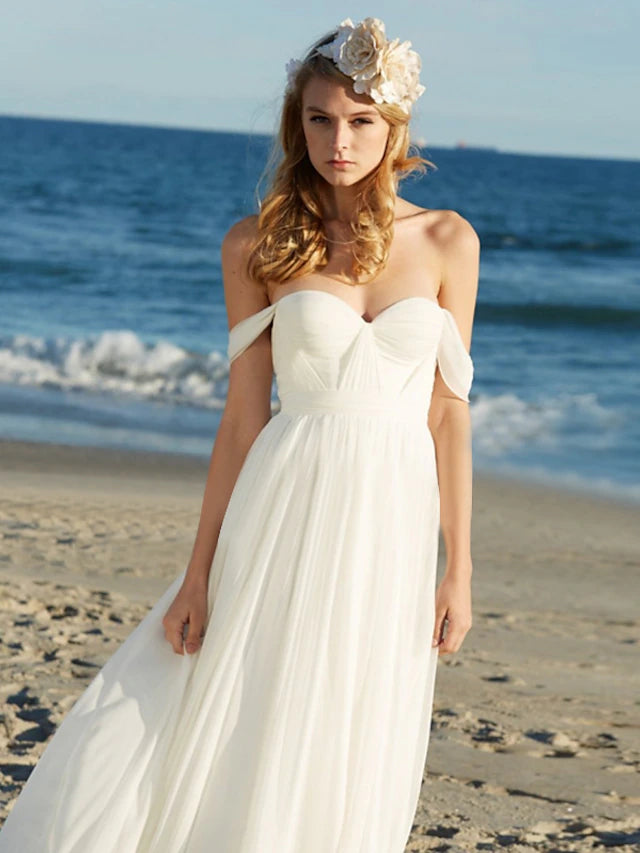 Boho floor-length wedding gown with delicate pleats.