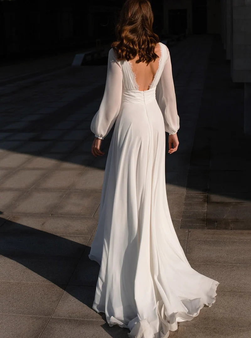 Side view of a flowy A-line wedding dress with long sleeves.
