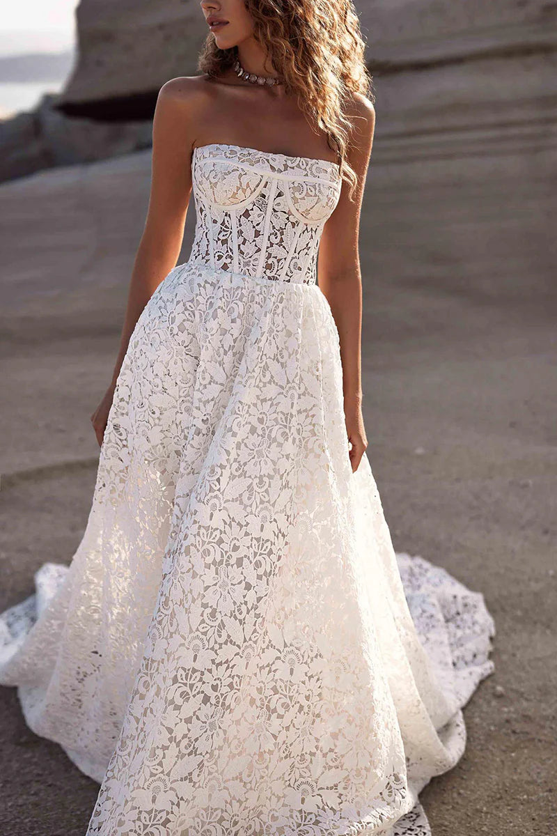 Boho lace A-line strapless wedding dress with flowing skirt.