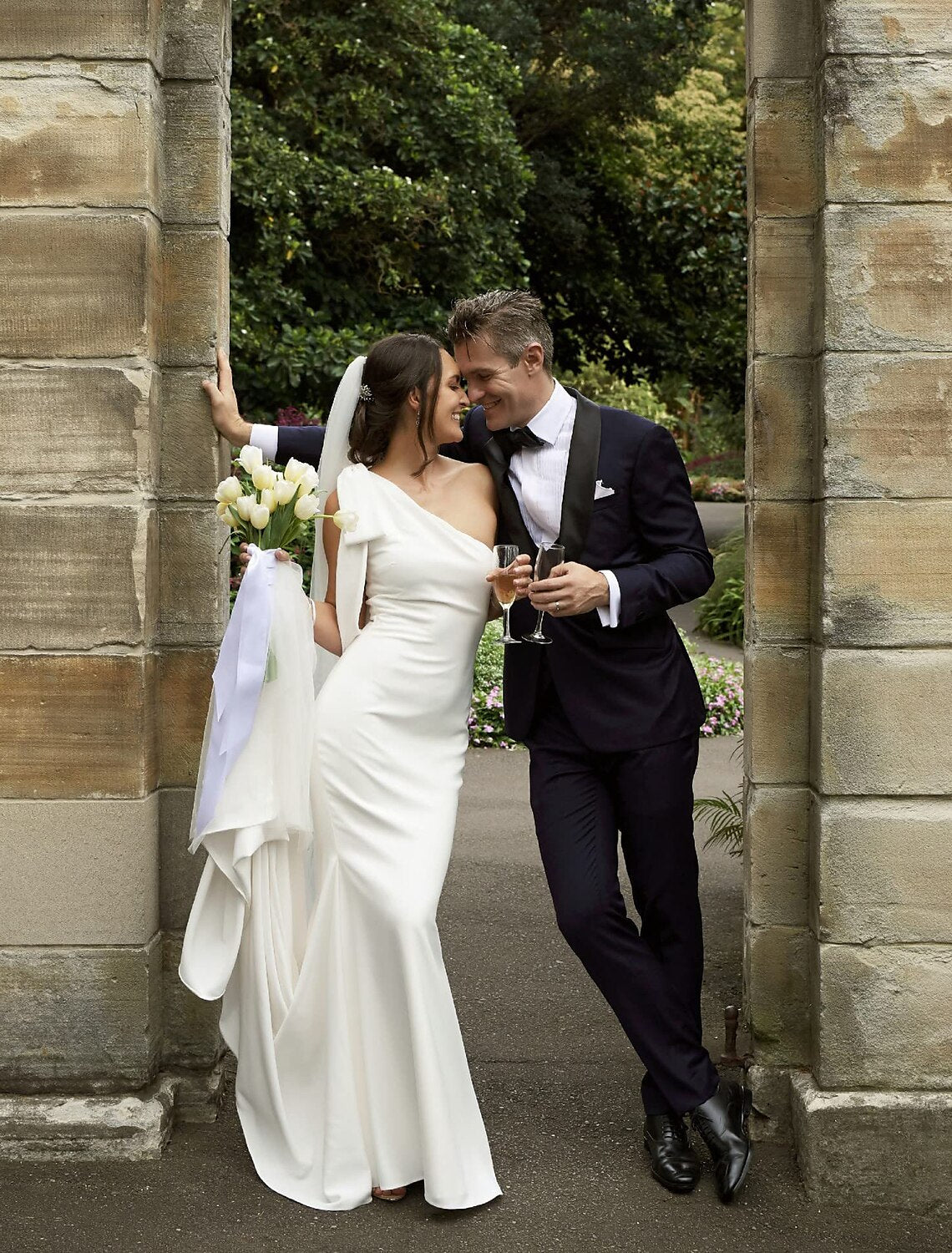 Elegant Boho Mermaid One Shoulder Wedding Dress with a bow and court train.