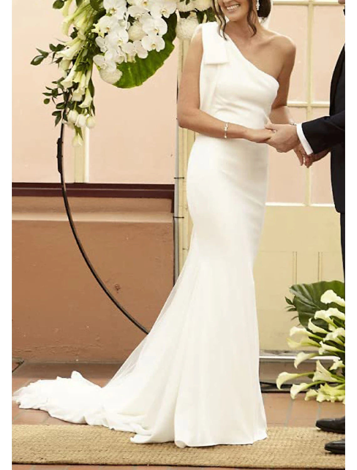 Back view of the wedding dress, showing the court train and bow detail.