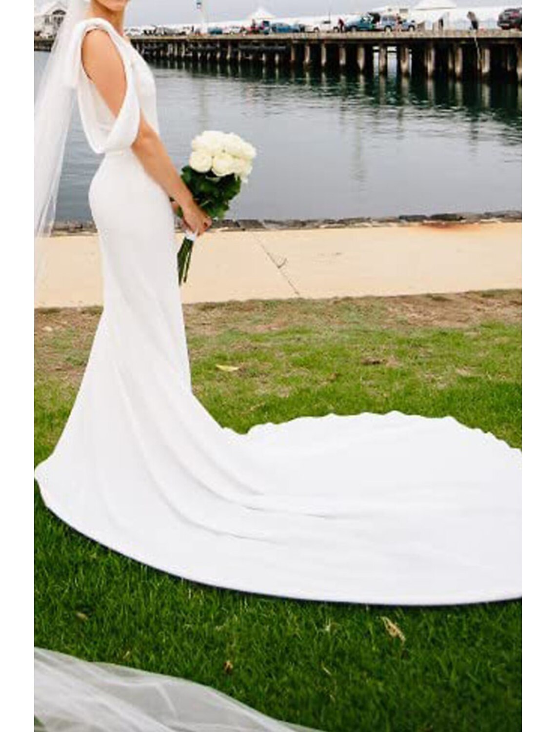 Close-up of the stretch fabric and bow embellishment on the bridal gown.