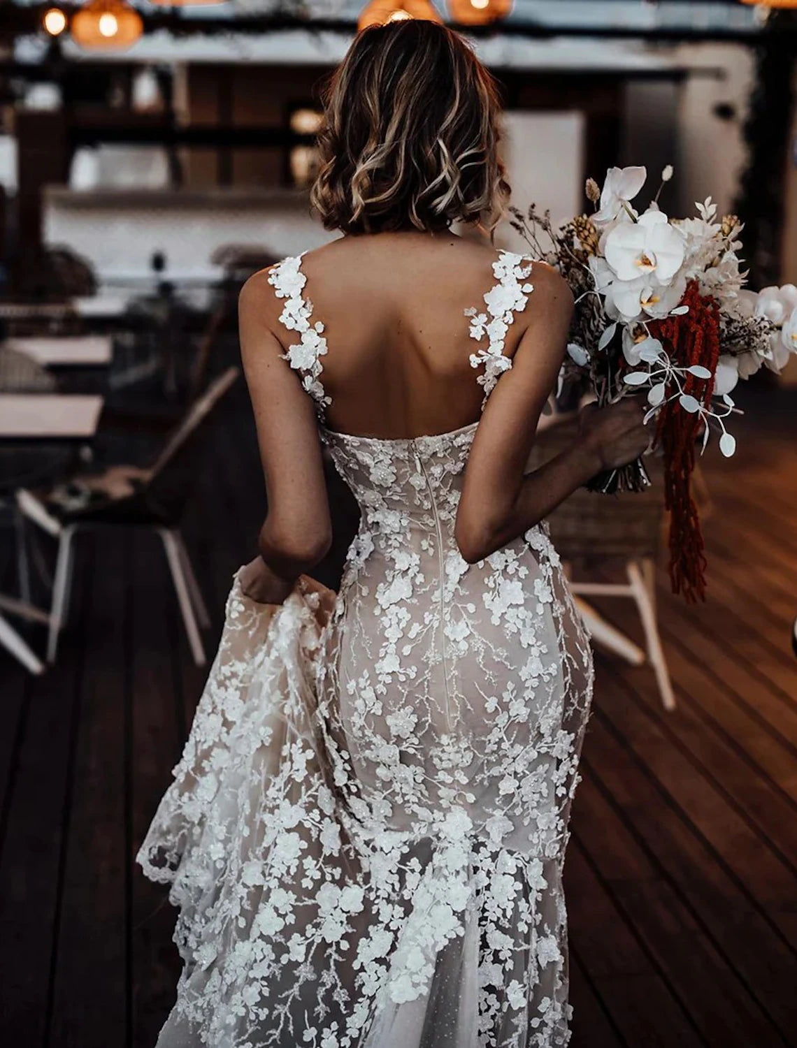 Close-up of lace appliques on a sweetheart mermaid wedding gown.
