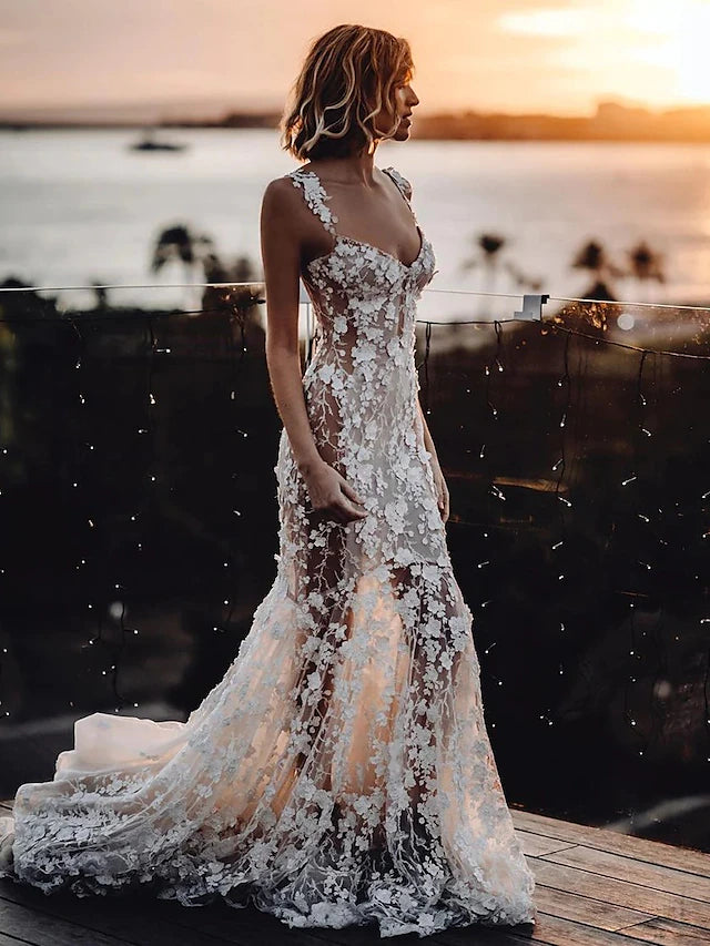 Close-up of delicate lace and appliques on a V-neck wedding gown.