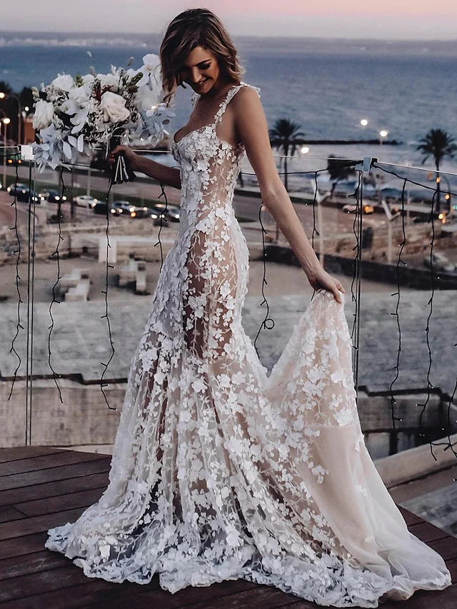 Side profile of a bride wearing a Mermaid Trumpet wedding dress with court train.