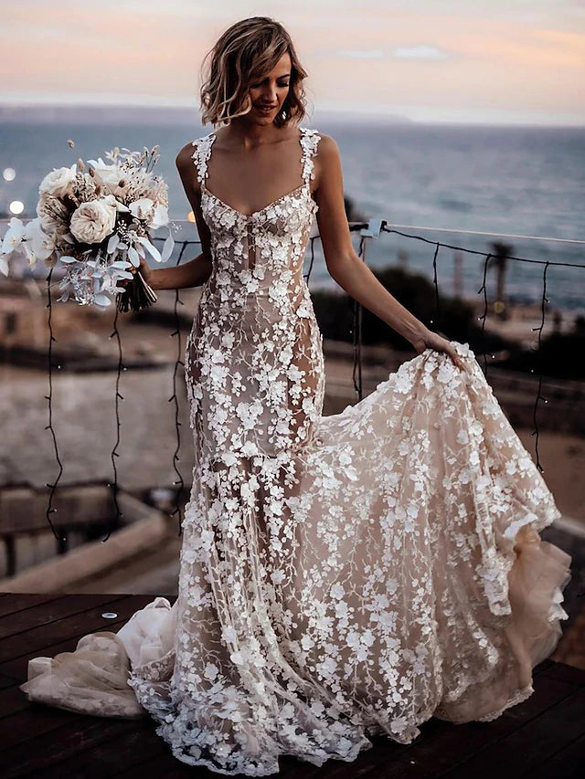 Full length view of a sleeveless V-neck lace wedding dress.