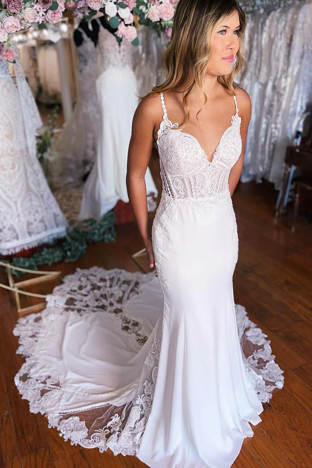 Elegant white Boho mermaid wedding dress with lace details and V-neck.