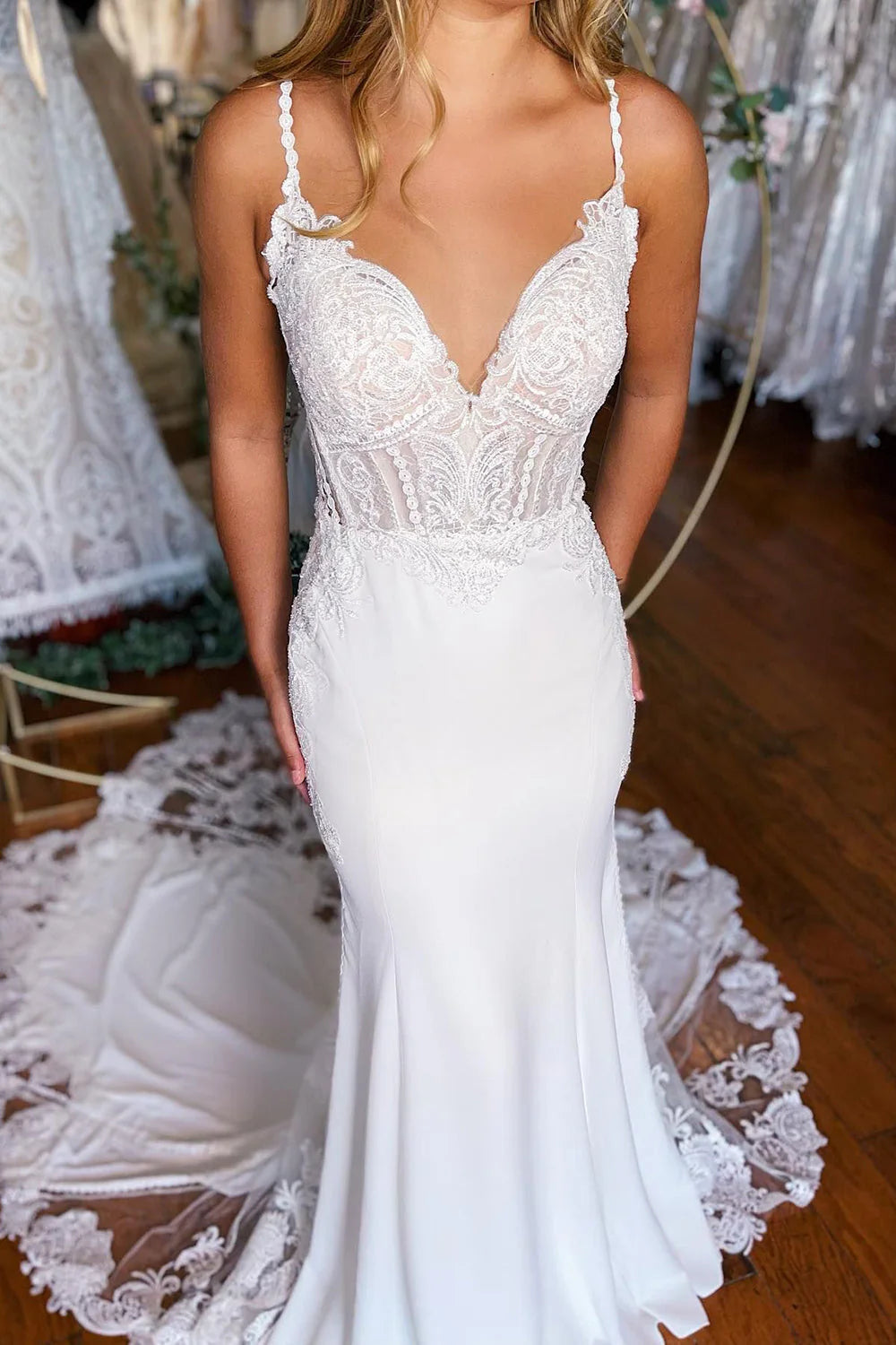 Back view of the white mermaid wedding dress showcasing lace and train.