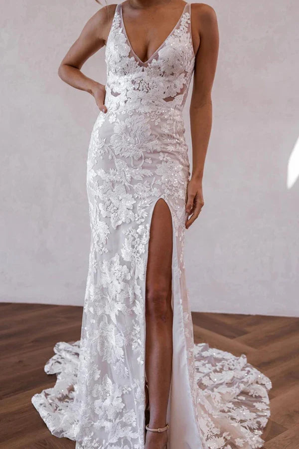 Boho mermaid wedding gown featuring a V-neck, lace, and a stylish leg slit.