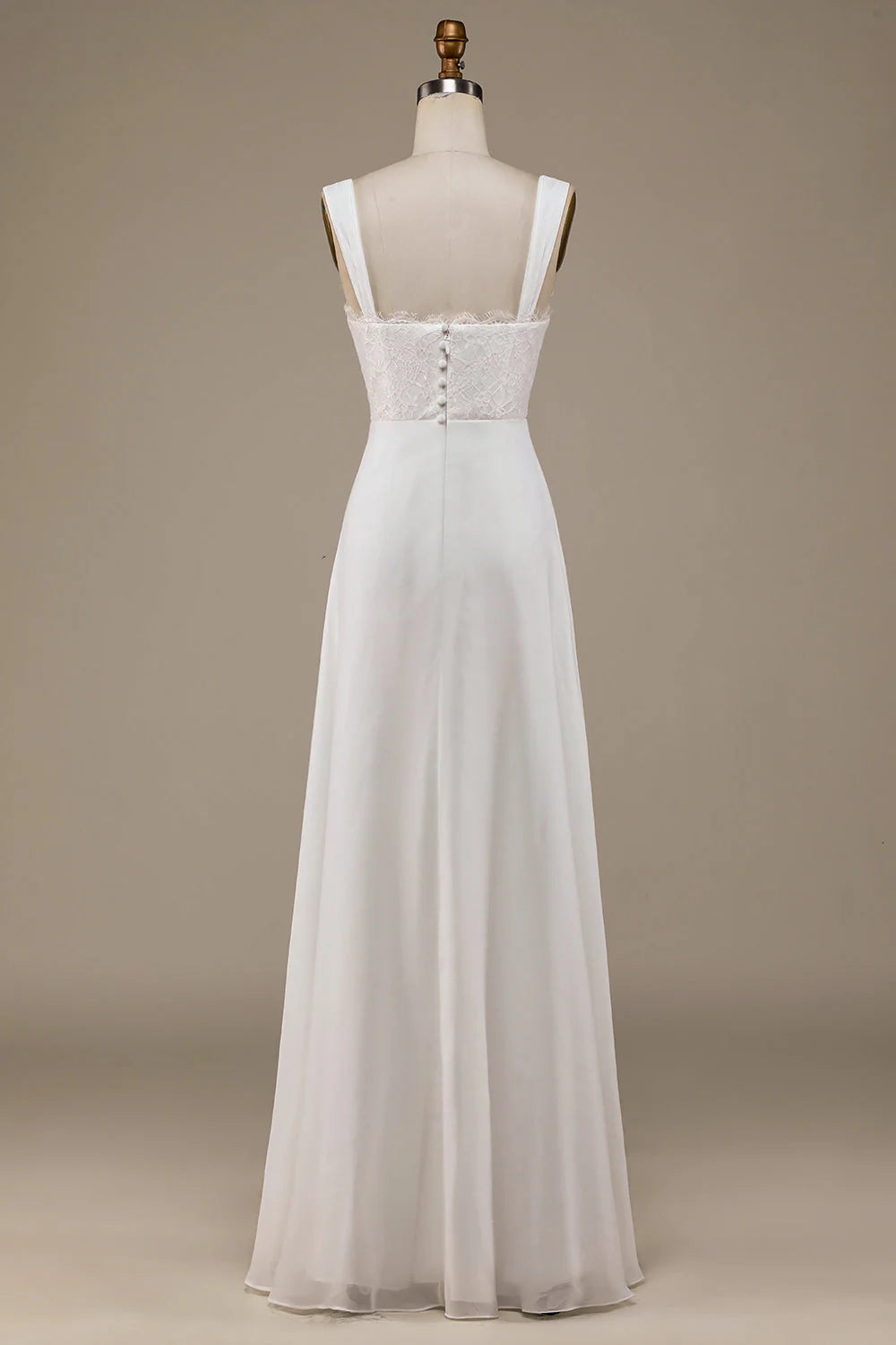 Side view of the flowing ivory boho wedding dress with lace details.