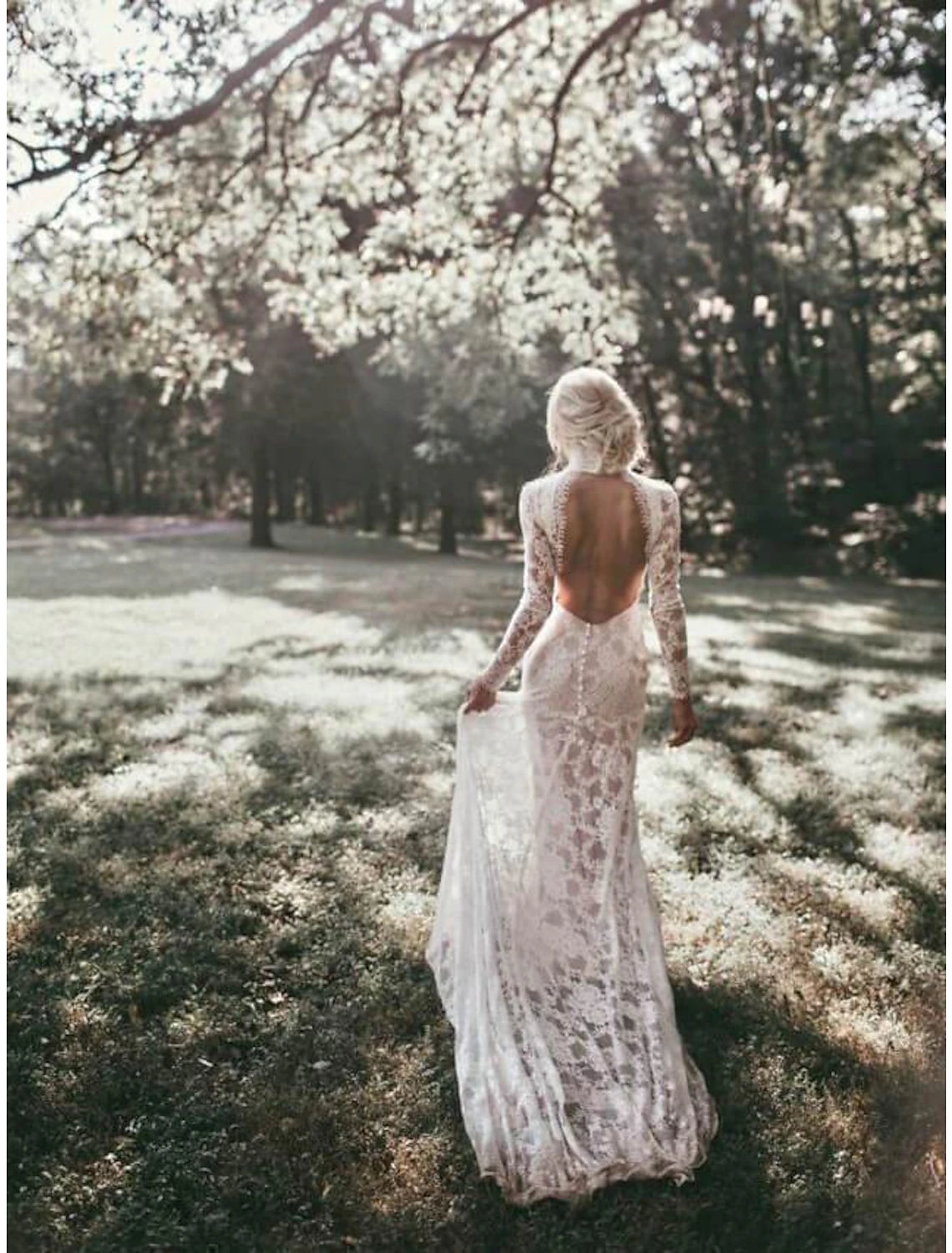 Side view of bride in high neck long sleeve lace wedding gown.