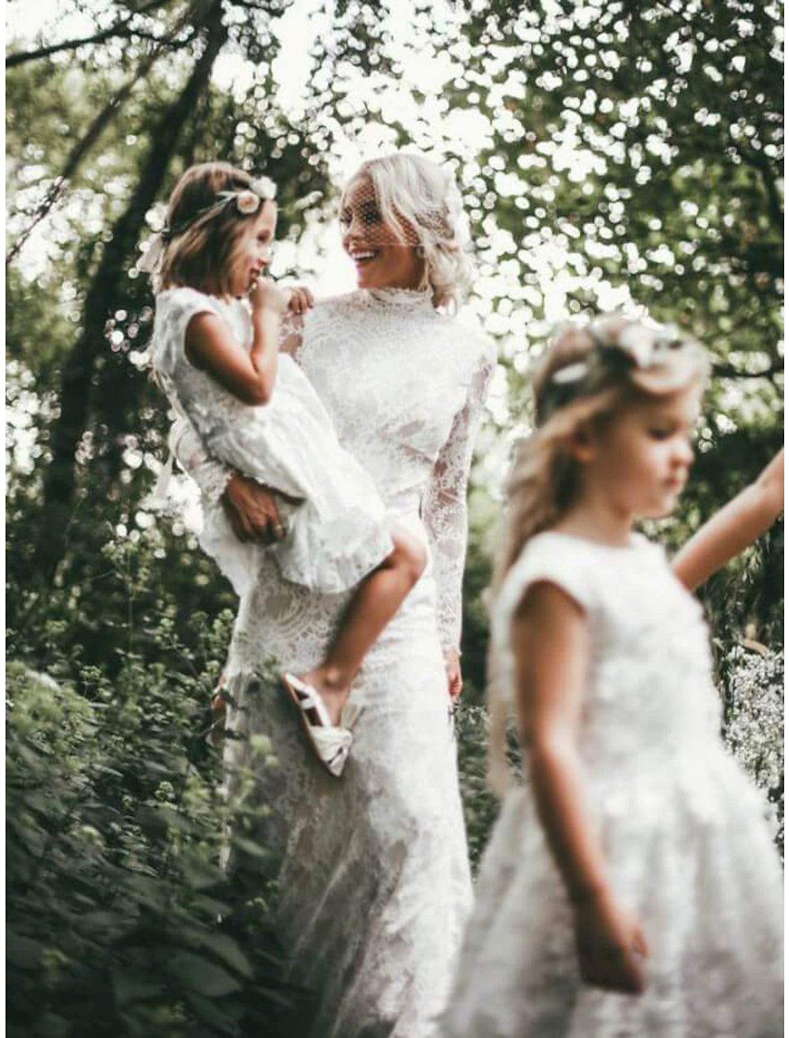 Close-up of lace appliques on the long sleeve of a bridal dress.