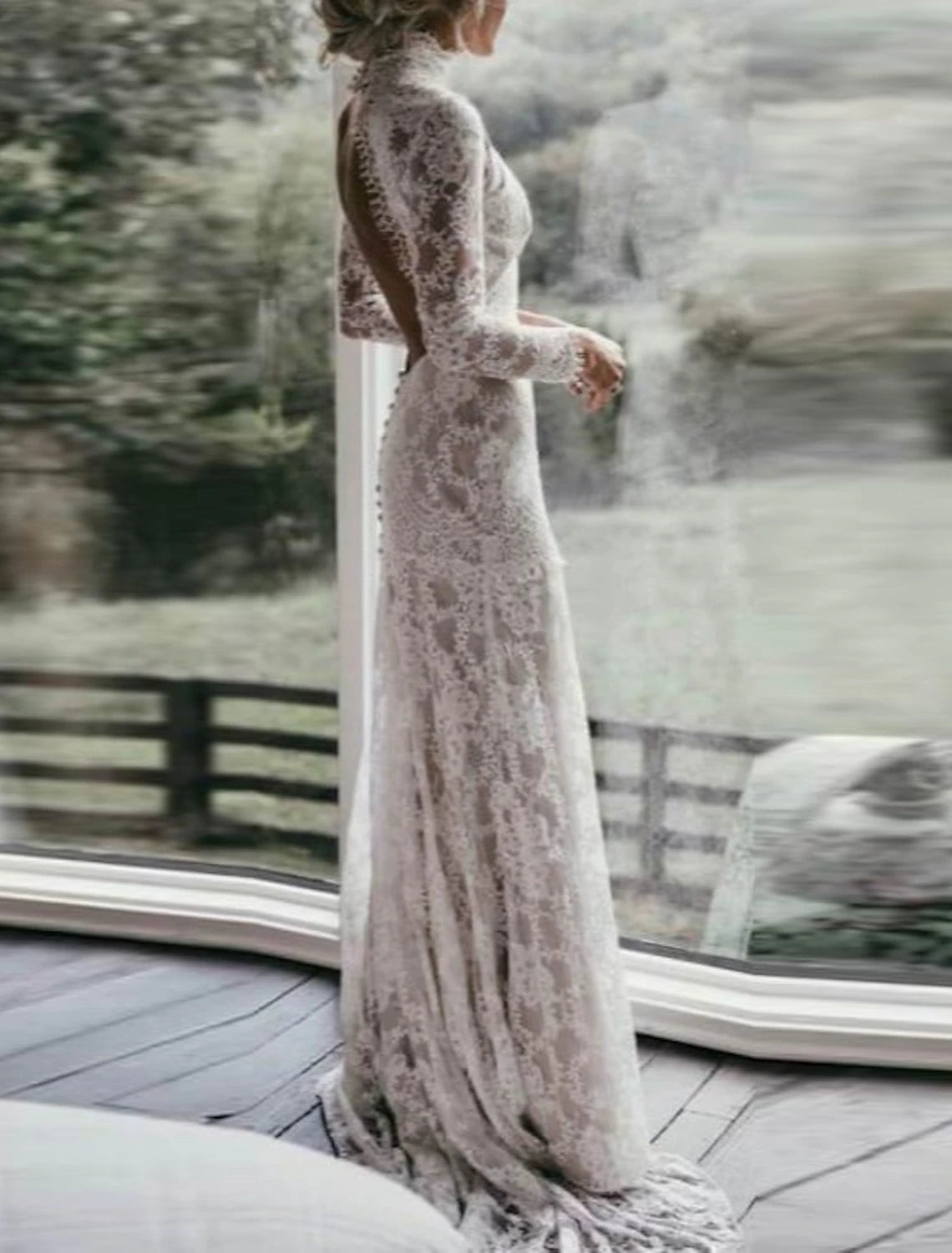 Full length view of elegant boho wedding dress with high neckline.